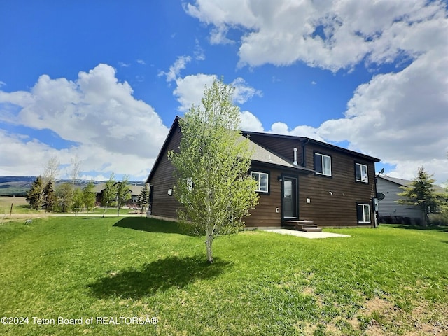 2929 Iron Wood Dr, Driggs, ID 83422 - rear view of house featuring a yard