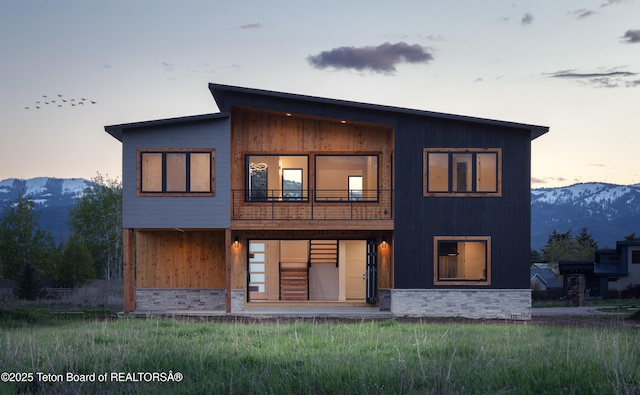 155 Sagewood Dr, Driggs, ID 83422 - rear view of house featuring a mountain view, a balcony, and stone siding
