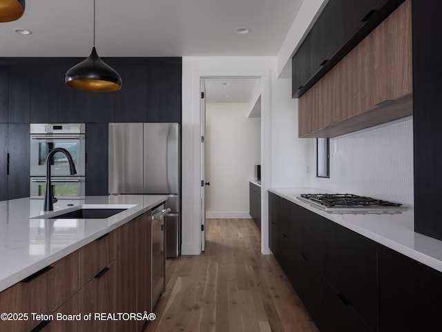 155 Sagewood Dr, Driggs, ID 83422 - kitchen featuring modern cabinets, appliances with stainless steel finishes, light wood-style flooring, pendant lighting, and recessed lighting