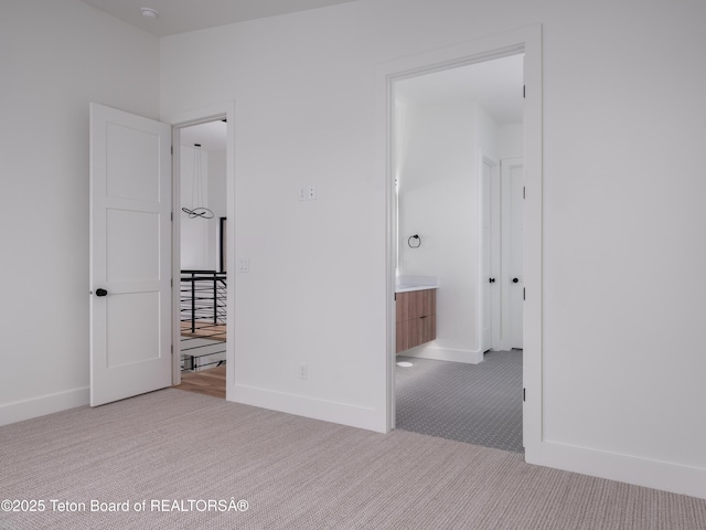 155 Sagewood Dr, Driggs, ID 83422 - unfurnished bedroom featuring carpet flooring, baseboards, and ensuite bath