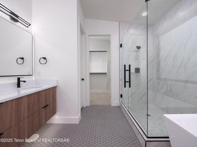 155 Sagewood Dr, Driggs, ID 83422 - bathroom featuring a shower stall, vanity, a freestanding tub, and baseboards