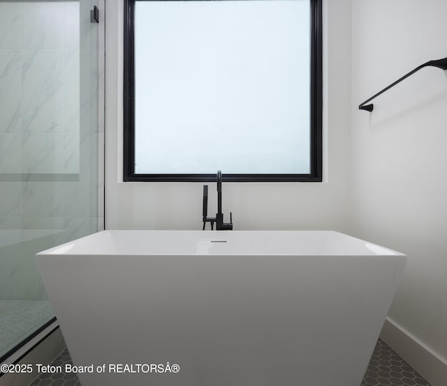 155 Sagewood Dr, Driggs, ID 83422 - bathroom featuring a freestanding bath, tile patterned flooring, and baseboards