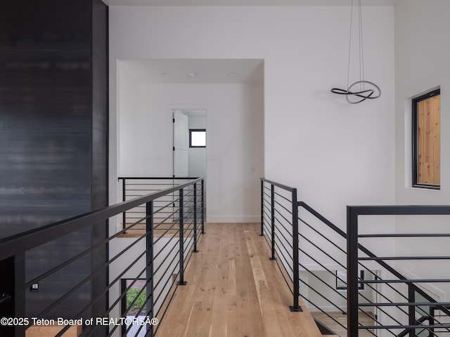 155 Sagewood Dr, Driggs, ID 83422 - hall with an upstairs landing, light wood-type flooring, and baseboards