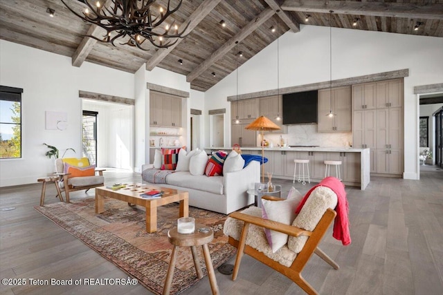 900 Mountain Bluebird Ct, Driggs, ID 83422 - living area with a chandelier, high vaulted ceiling, light wood finished floors, wood ceiling with exposed beams, and baseboards