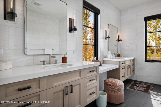 900 Mountain Bluebird Ct, Driggs, ID 83422 - bathroom featuring tile walls, vanity, healthy amount of natural light, and tile patterned flooring