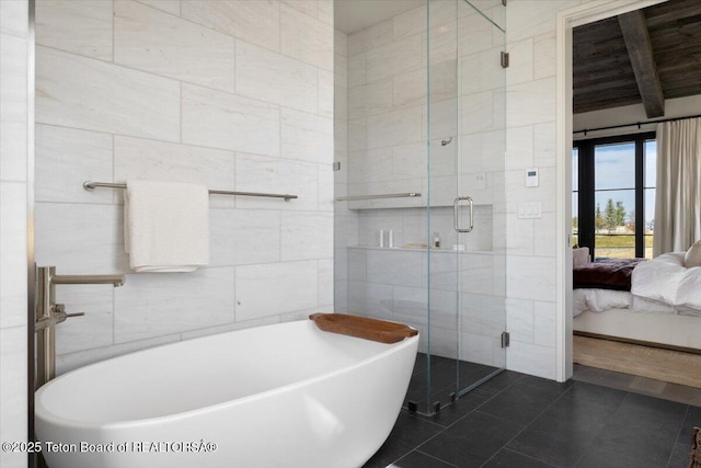 900 Mountain Bluebird Ct, Driggs, ID 83422 - ensuite bathroom with tile walls, a freestanding tub, a shower stall, and tile patterned flooring