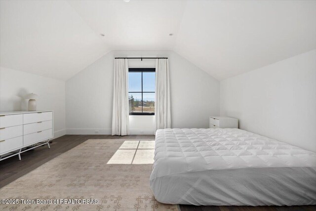 900 Mountain Bluebird Ct, Driggs, ID 83422 - bedroom with wood finished floors, lofted ceiling, and baseboards