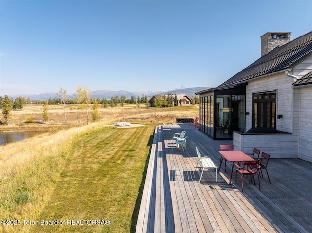900 Mountain Bluebird Ct, Driggs, ID 83422 - wooden terrace with a mountain view, outdoor dining space, and a yard