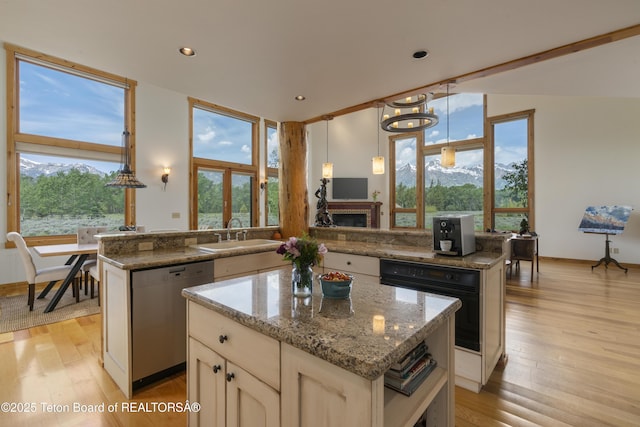 500 E Solitude Dr, Jackson, WY 83001 - kitchen with stainless steel dishwasher, a center island, a sink, oven, and a peninsula