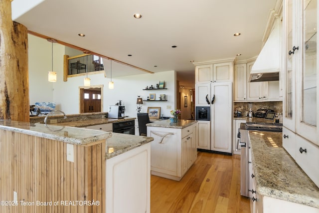 500 E Solitude Dr, Jackson, WY 83001 - kitchen featuring paneled refrigerator, a kitchen island, premium range hood, light wood-type flooring, and dishwashing machine