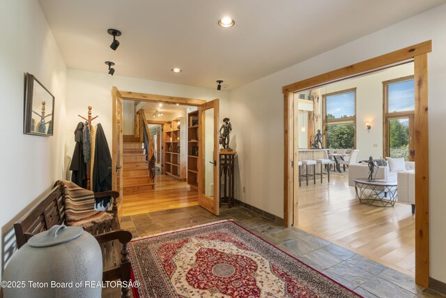 500 E Solitude Dr, Jackson, WY 83001 - corridor featuring stone tile floors, stairway, recessed lighting, and baseboards