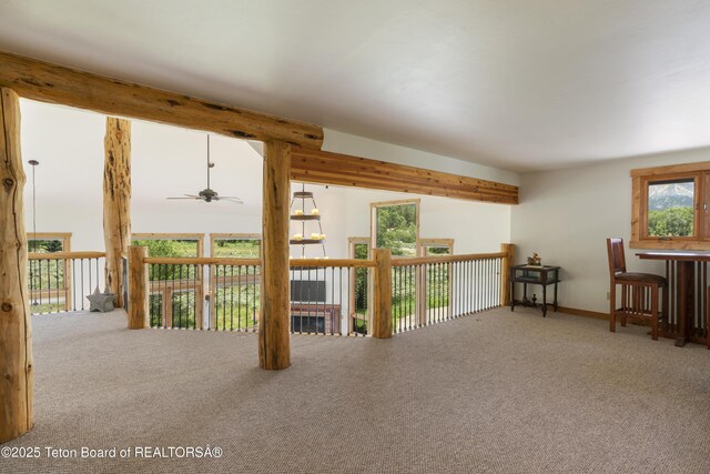 500 E Solitude Dr, Jackson, WY 83001 - living area featuring a ceiling fan, carpet flooring, baseboards, and beam ceiling