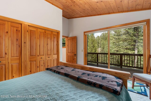 25655 Buffalo Run, Moran, WY 83013 - carpeted bedroom featuring access to exterior, wood ceiling, and crown molding