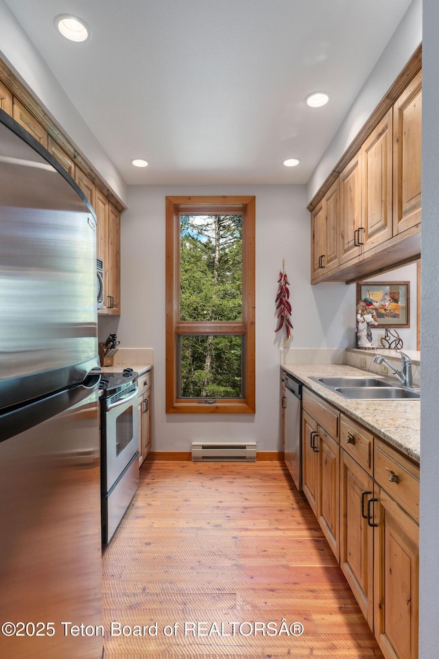 25655 Buffalo Run, Moran, WY 83013 - kitchen featuring appliances with stainless steel finishes, a sink, a baseboard heating unit, light wood-style floors, and recessed lighting