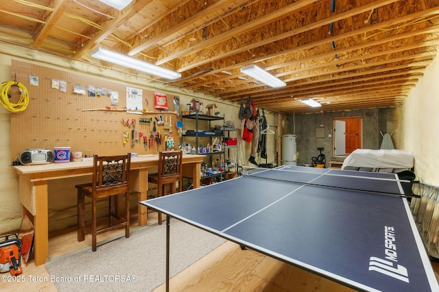 25655 Buffalo Run, Moran, WY 83013 - game room featuring a workshop area, water heater, and wood finished floors