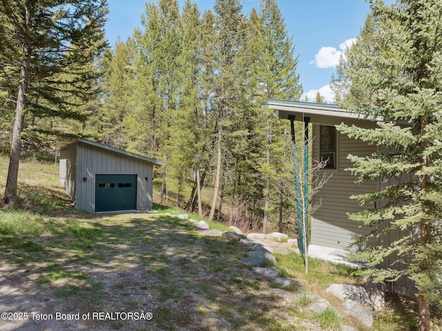 25655 Buffalo Run, Moran, WY 83013 - view of yard with an outdoor structure, a garage, and dirt driveway