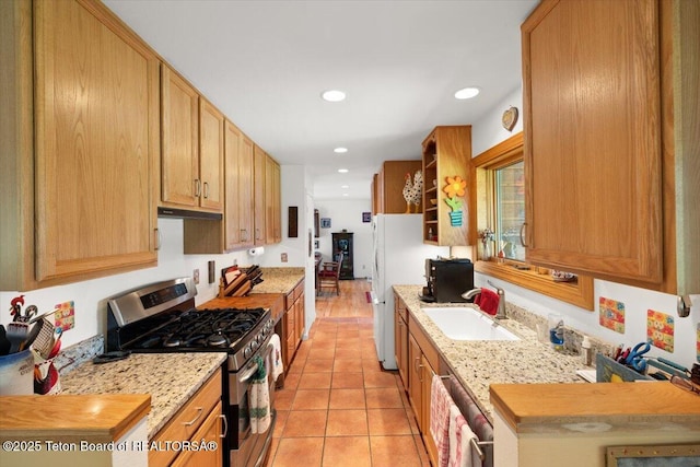 3470 S Winding Trail Dr, Jackson, WY 83001 - kitchen with stainless steel appliances, a sink, under cabinet range hood, light tile patterned flooring, and recessed lighting