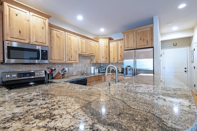 125 Cobble Creek Ln Unit 75, Driggs, ID 83422 - kitchen featuring appliances with stainless steel finishes, a sink, stone counters, backsplash, and recessed lighting
