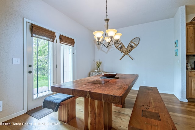 125 Cobble Creek Ln Unit 75, Driggs, ID 83422 - dining room with dark wood finished floors, a chandelier, baseboards, and a textured wall