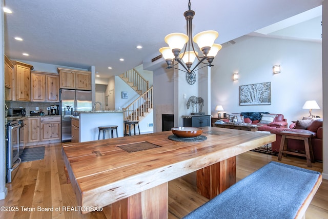125 Cobble Creek Ln Unit 75, Driggs, ID 83422 - dining area with a chandelier, stairway, recessed lighting, and light wood-style floors