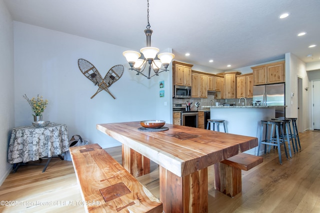 125 Cobble Creek Ln Unit 75, Driggs, ID 83422 - dining area with recessed lighting, a chandelier, light wood-style floors, and baseboards