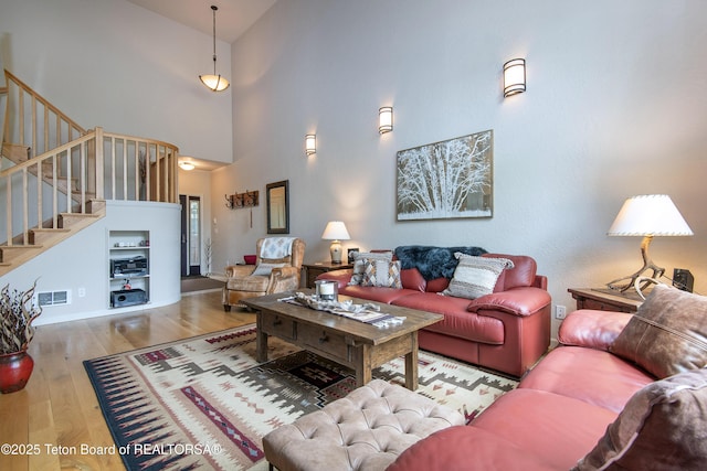 125 Cobble Creek Ln Unit 75, Driggs, ID 83422 - living area with a high ceiling, stairway, wood finished floors, and baseboards