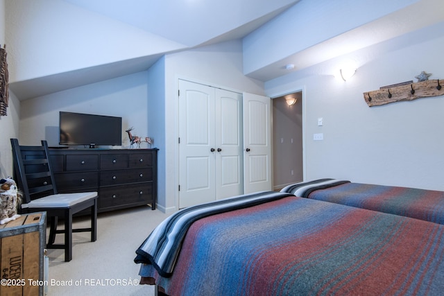 125 Cobble Creek Ln Unit 75, Driggs, ID 83422 - bedroom with lofted ceiling, light carpet, and a closet