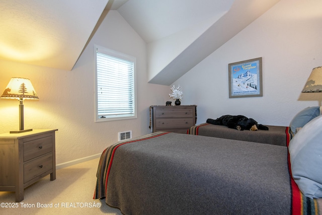 125 Cobble Creek Ln Unit 75, Driggs, ID 83422 - bedroom with light carpet, lofted ceiling, and baseboards