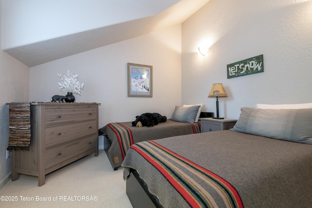125 Cobble Creek Ln Unit 75, Driggs, ID 83422 - bedroom featuring lofted ceiling, light colored carpet, and baseboards