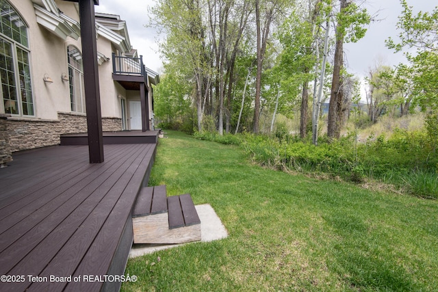 125 Cobble Creek Ln Unit 75, Driggs, ID 83422 - view of green lawn featuring a balcony and a deck