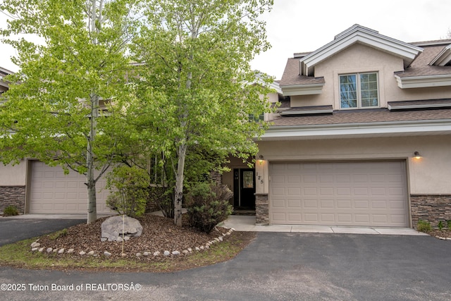 125 Cobble Creek Ln Unit 75, Driggs, ID 83422 - view of front facade featuring stucco siding, stone siding, and asphalt driveway