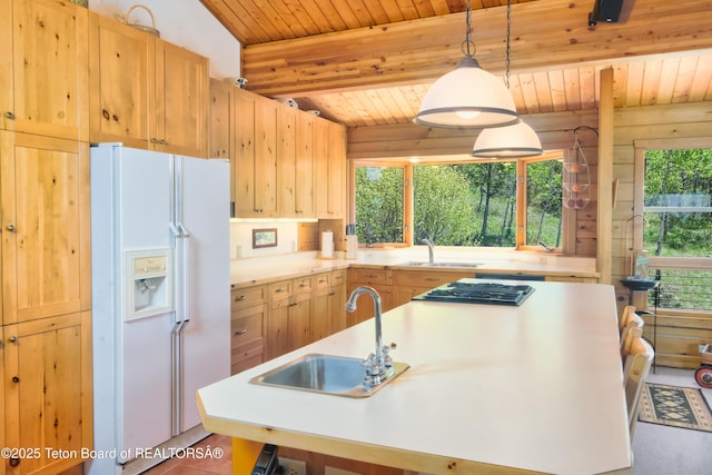 3190 Sorensen Creek Dr, Victor, ID 83455 - kitchen with white refrigerator with ice dispenser, a sink, light brown cabinetry, plenty of natural light, and wooden ceiling with exposed beams