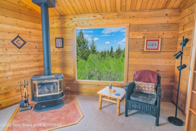 3190 Sorensen Creek Dr, Victor, ID 83455 - sitting room with a wood stove, wooden ceiling, and wooden walls