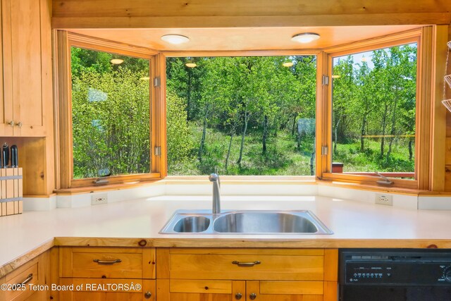 3190 Sorensen Creek Dr, Victor, ID 83455 - kitchen featuring black dishwasher, a sink, and light countertops