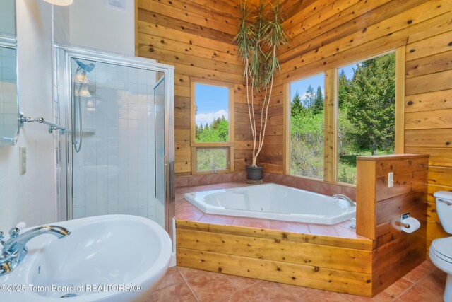 3190 Sorensen Creek Dr, Victor, ID 83455 - full bathroom with a sink, toilet, tile patterned floors, a garden tub, and wooden walls