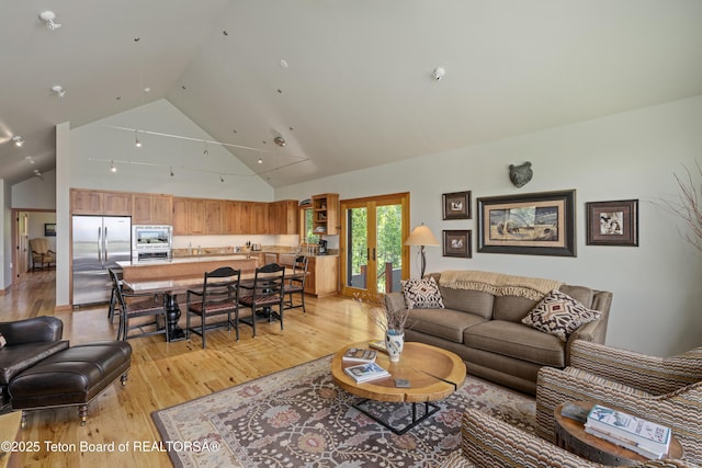 25000 N Deer Ct, Moran, WY 83013 - living room featuring french doors, light wood finished floors, and high vaulted ceiling