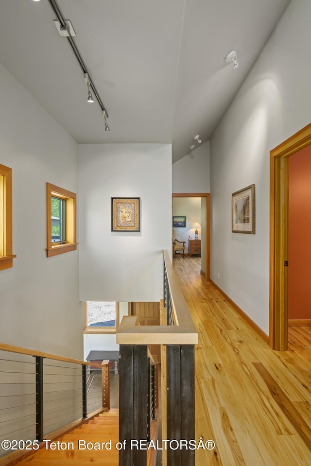 25000 N Deer Ct, Moran, WY 83013 - hallway featuring an upstairs landing, track lighting, wood finished floors, and baseboards