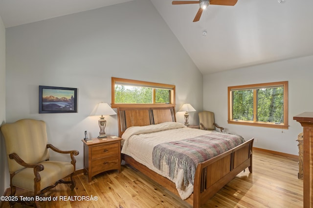 25000 N Deer Ct, Moran, WY 83013 - bedroom featuring multiple windows, baseboards, light wood-style floors, high vaulted ceiling, and ceiling fan