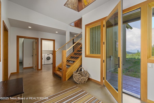 25000 N Deer Ct, Moran, WY 83013 - foyer entrance with washing machine and dryer, finished concrete flooring, recessed lighting, baseboards, and stairs