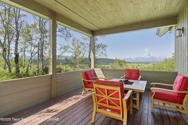 25000 N Deer Ct, Moran, WY 83013 - wooden deck featuring a mountain view and outdoor dining area