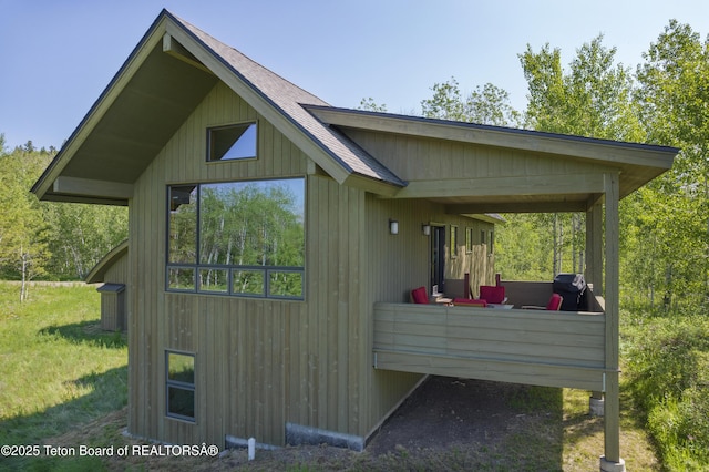 25000 N Deer Ct, Moran, WY 83013 - view of property exterior with a shingled roof and a yard