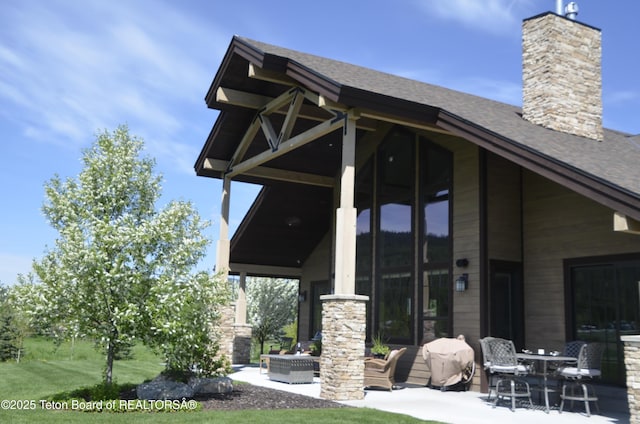 1795 Fumarole Dr, Victor, ID 83455 - rear view of property with a patio, a chimney, and roof with shingles