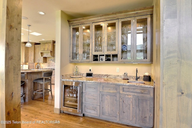 1795 Fumarole Dr, Victor, ID 83455 - indoor wet bar featuring beverage cooler, light wood-style floors, pendant lighting, and recessed lighting