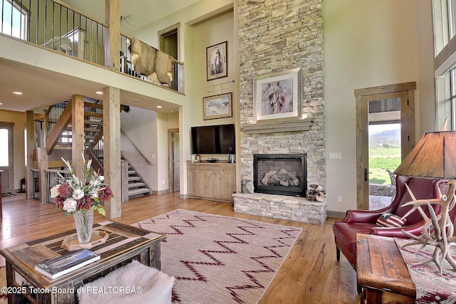 1795 Fumarole Dr, Victor, ID 83455 - living area featuring a high ceiling, plenty of natural light, stairs, hardwood / wood-style flooring, and a fireplace