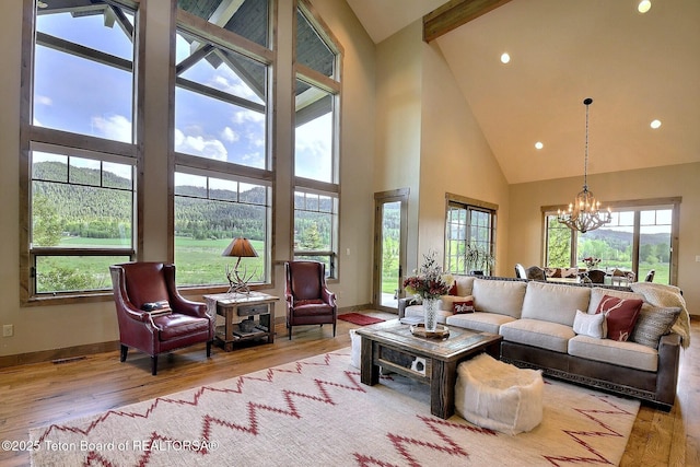 1795 Fumarole Dr, Victor, ID 83455 - living area featuring high vaulted ceiling, a chandelier, wood finished floors, recessed lighting, and a mountain view