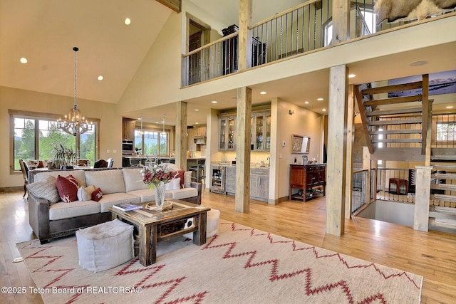 1795 Fumarole Dr, Victor, ID 83455 - living area featuring high vaulted ceiling, wood finished floors, wine cooler, a chandelier, and recessed lighting