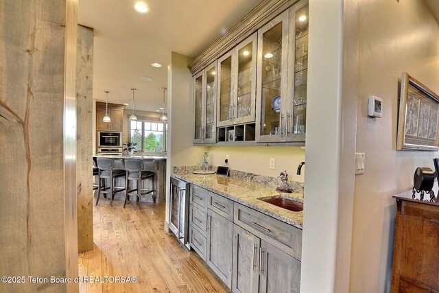 1795 Fumarole Dr, Victor, ID 83455 - indoor wet bar with wine cooler, light wood finished floors, recessed lighting, and pendant lighting