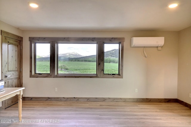 1795 Fumarole Dr, Victor, ID 83455 - empty room with a wall mounted air conditioner, wood finished floors, healthy amount of natural light, and recessed lighting