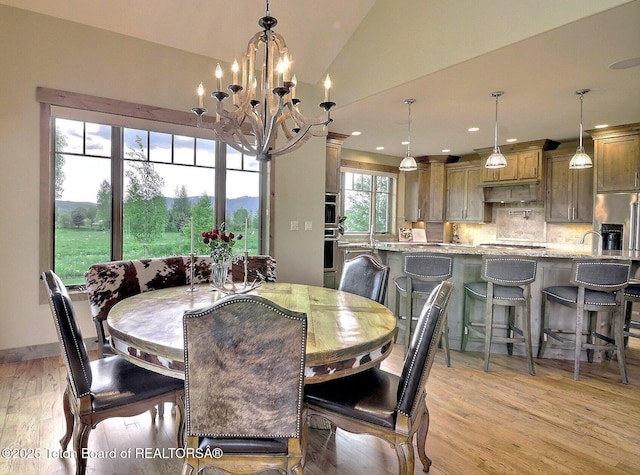 1795 Fumarole Dr, Victor, ID 83455 - dining space with light wood-style floors, a chandelier, vaulted ceiling, and recessed lighting