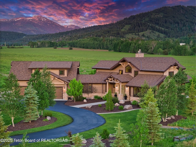 1795 Fumarole Dr, Victor, ID 83455 - view of front of property featuring a mountain view, a yard, asphalt driveway, and a view of trees